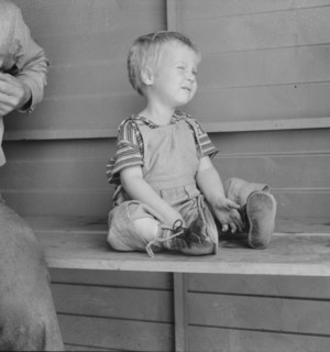 Baby with club feet wearing homemade splints, FSA camp, Tulare County, California, 1939. Creator: Dorothea Lange.