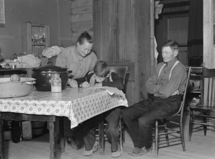 The Wardlow family in their dugout basement home on Sunday, Dead Ox Flat, Oregon, 1939. Creator: Dorothea Lange.