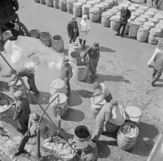 Possibly: Fulton fish market dock stevedores unloading and weighing fish in the..., New York, 1943. Creator: Gordon Parks.