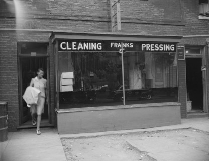 Possibly: A tailor in Frank's cleaning and pressing establishment checking..., Washington, DC, 1942. Creator: Gordon Parks.