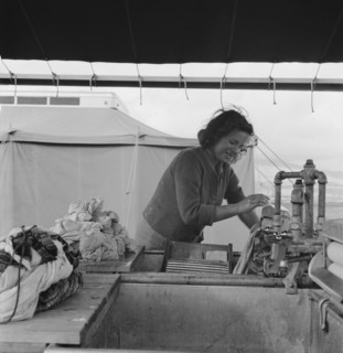 Young migrant girl makes use of facilities..., Merrill FSA camp, Klamath County, Oregon, 1939. Creator: Dorothea Lange.