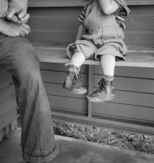 Baby with club feet wearing homemade splints, FSA camp, Tulare County, California, 1939. Creator: Dorothea Lange.