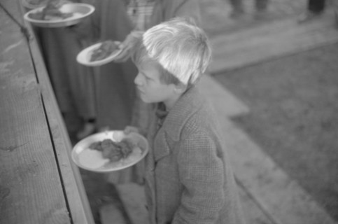 Possibly: Negroes in the lineup for food at mealtime in the camp..., Forrest City, Arkansas, 1937. Creator: Walker Evans.