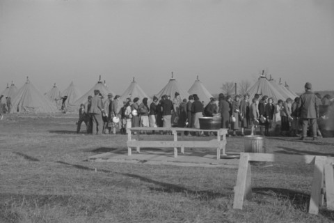 Possibly: Refugees lined up at meal time in the camp for white flood...Forest City, Arkansas, 1937. Creator: Walker Evans.
