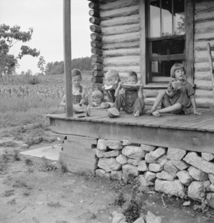 Millworker's children eating watermelon on porch..., Person County, North Carolina, 1939. Creator: Dorothea Lange.
