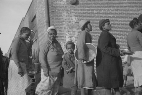 Possibly: Negroes in the lineup for food at the flood refugee camp, Forrest City, Arkansas, 1937. Creator: Walker Evans.