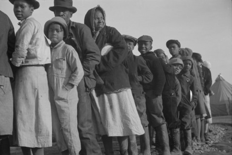 Possibly: Negroes in the lineup for food at the flood refugee camp, Forrest City, Arkansas, 1937. Creator: Walker Evans.
