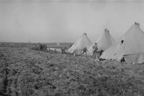 Possibly: Setting up a tent in the camp for white flood refugees, Forrest City, Arkansas, 1937. Creator: Walker Evans.