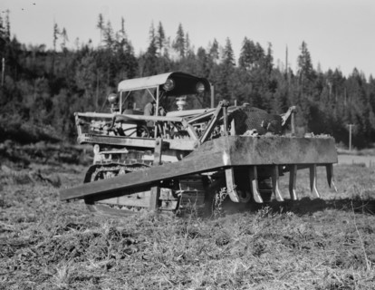 Possibly: Bulldozer raises and pushes stump on cut-over farm, Lewis County, Western Washington, 1939 Creator: Dorothea Lange.