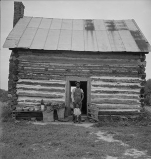 Possibly: Young sharecropper and his first child, Hillside Farm, Person County, North Carolina, 1939 Creator: Dorothea Lange.
