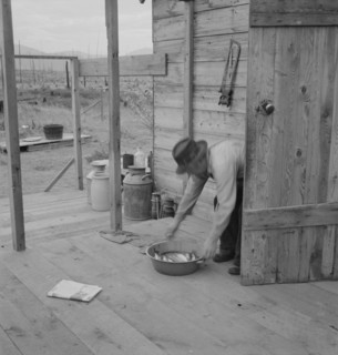 New settler shows fish he caught..., Priest River Valley, Bonner County, Idaho, 1939. Creator: Dorothea Lange.