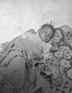 Child seriously ill from an infection caused by a rat bite in her home..., Washington, D.C., 1942. Creator: Gordon Parks.