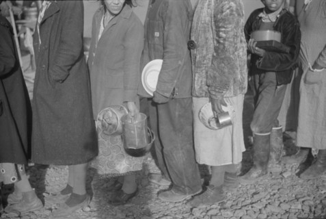 Possibly: Negroes at mealtime in the flood refugee camp, Forrest City, Arkansas, 1937. Creator: Walker Evans.