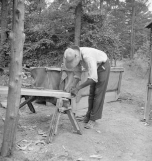 Zollie Lyons repairing the tobacco sleds at...harvest season, Wake County, North Carolina, 1939. Creator: Dorothea Lange.