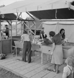 Portable laundry unit, shower unit beyond, FSA camp, Merrill, Oregon, 1939. Creator: Dorothea Lange.