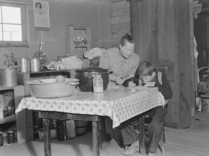 The youngest Wardlow boy copies out a recipe for his mother. Dead Ox Flat, Malheur County, Oregon.