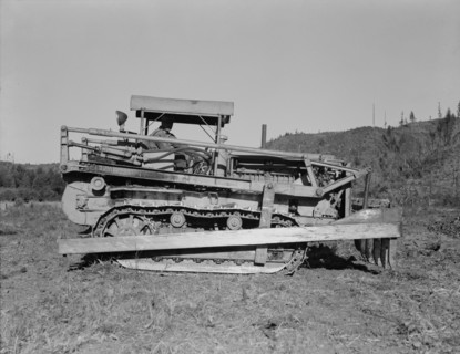 Western Washington, Lewis County. Caterpillar clearing land on cut-over western Washington farm.