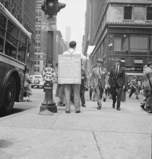 42nd Street and Madison Avenue. Street hawker selling Consumer's Bureau Guide. New York City.
