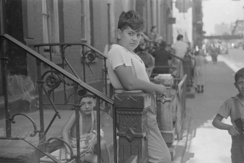 New York, New York. 61st Street between 1st and 3rd Avenues. Children playing in the street.