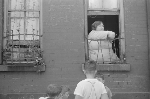 New York, New York. 61st Street between 1st and 3rd Avenues. Children playing in the street.