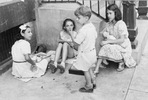 New York, New York. 61st Street between 1st and 3rd Avenues. Children playing in the street.