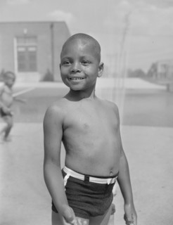 Anacostia, D.C. Frederick Douglass housing project. Cooling off under the community sprayer.