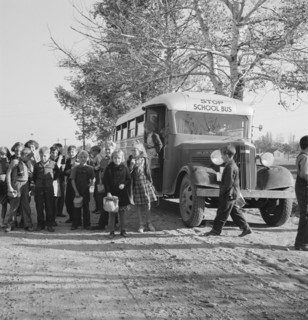 The children from Dead Ox Flat get off bus at school yard. Ontario, Malheur County, Oregon.