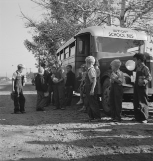 The children from Dead Ox Flat get off bus at school yard. Ontario, Malheur County, Oregon.