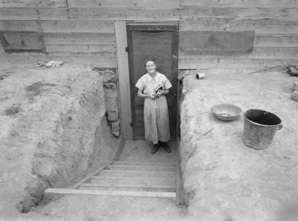 Mrs. Free in doorway of her basement dugout home. Dead Ox Flat, Malheur County, Oregon.