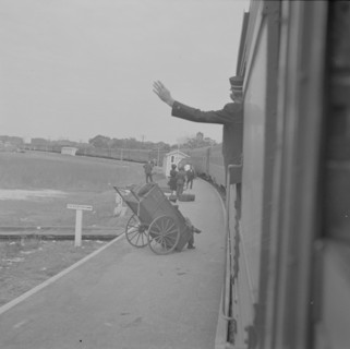 Saint Augustine, Florida. Trainman signalling from a "Jim Crow" coach.