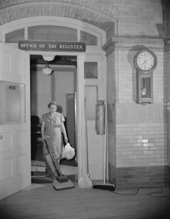 Washington, D.C. Government charwoman cleaning after regular hours.