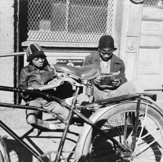 Washington, D.C. Two Negro boys reading the funnies on a doorstep.