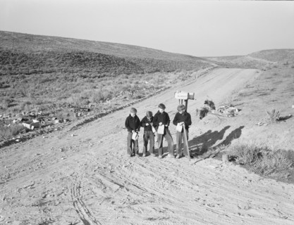 Boys wait for school bus in the morning. Malheur County, Oregon.