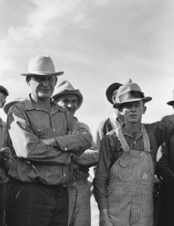 Watching ball game. Shafter camp for migrants. California.