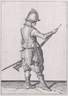 A soldier ramming home powder and bullet with the ramrod, from the Marksmen seri..., published 1608. Creator: Robert Willemsz de Baudous.