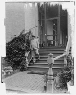 Admiral George Dewey on steps of house, Washington D.C., between 1890 and 1910. Creator: Levin Handy.