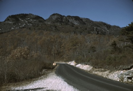 The road along the Skyline Drive, with a light snowfall in the rocks beside, Virginia, ca. 1940. Creator: Jack Delano.