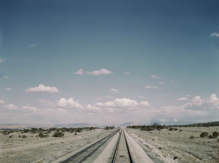 Flagman standing behind his train to flag oncoming trains at a small siding..., New Mexico, 1943. Creator: Jack Delano.