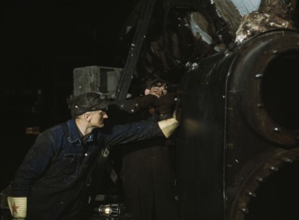 Working on the cylinder of a locomotive at the C & NW RR, 40th Street shops, Chicago, Ill., 1942. Creator: Jack Delano.