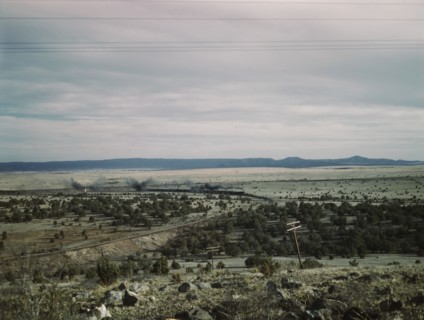West-bound passenger train going around a curve on the Atchison..., near Gleed, Arizona, 1943. Creator: Jack Delano.