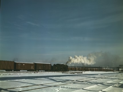 A train pulling out of the freight house at C & NW RR's Proviso(?) yard, Chicago, Ill., 1942. Creator: Jack Delano.