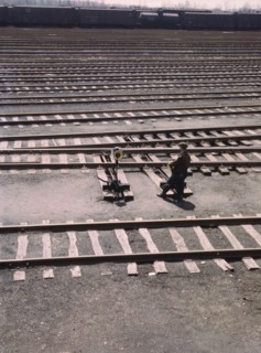 Switchman throwing a switch a C and NW RR's Proviso yard, Chicago, Ill., 1943. Creator: Jack Delano.