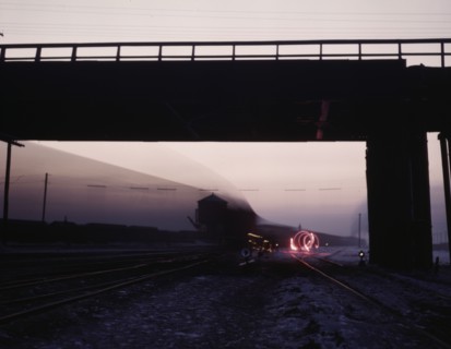 View in a departure yard at C & NW RR's Proviso (?) yard at twilight, Chicago, Ill., 1942. Creator: Jack Delano.