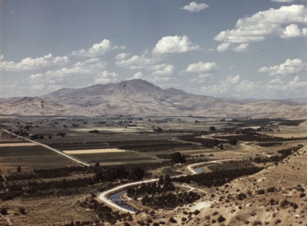 Cherry orchards, farm lands and irrigation ditch at Emmett, Idaho, 1941. Creator: Russell Lee.