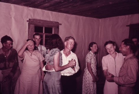 Scene at square dance in rural home in McIntosh County, Oklahoma, 1939 or 1940. Creator: Russell Lee.