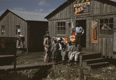 Migratory laborers outside of a "juke joint" during a slack season, Belle Glade, Fla., 1941. Creator: Marion Post Wolcott.