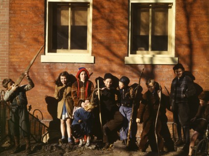 Children aiming sticks as guns, lined up against a brick building, Washington, D.C.?, 1941-1942. Creator: Unknown.