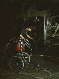 Thomas Madrigal greasing a locomotive in the roundhouse, Rock Island R.R., Blue Island, Ill., 1943. Creator: Jack Delano.