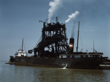Loading coal into a freighter at one of the Pennsylvania Railroad docks, Sandusky, Ohio, 1943. Creator: Jack Delano.