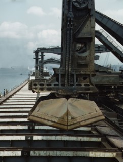 Pennsylvania R.R. ore docks, unloading iron ore from a lake freighter..., Cleveland, Ohio, 1943. Creator: Jack Delano.
